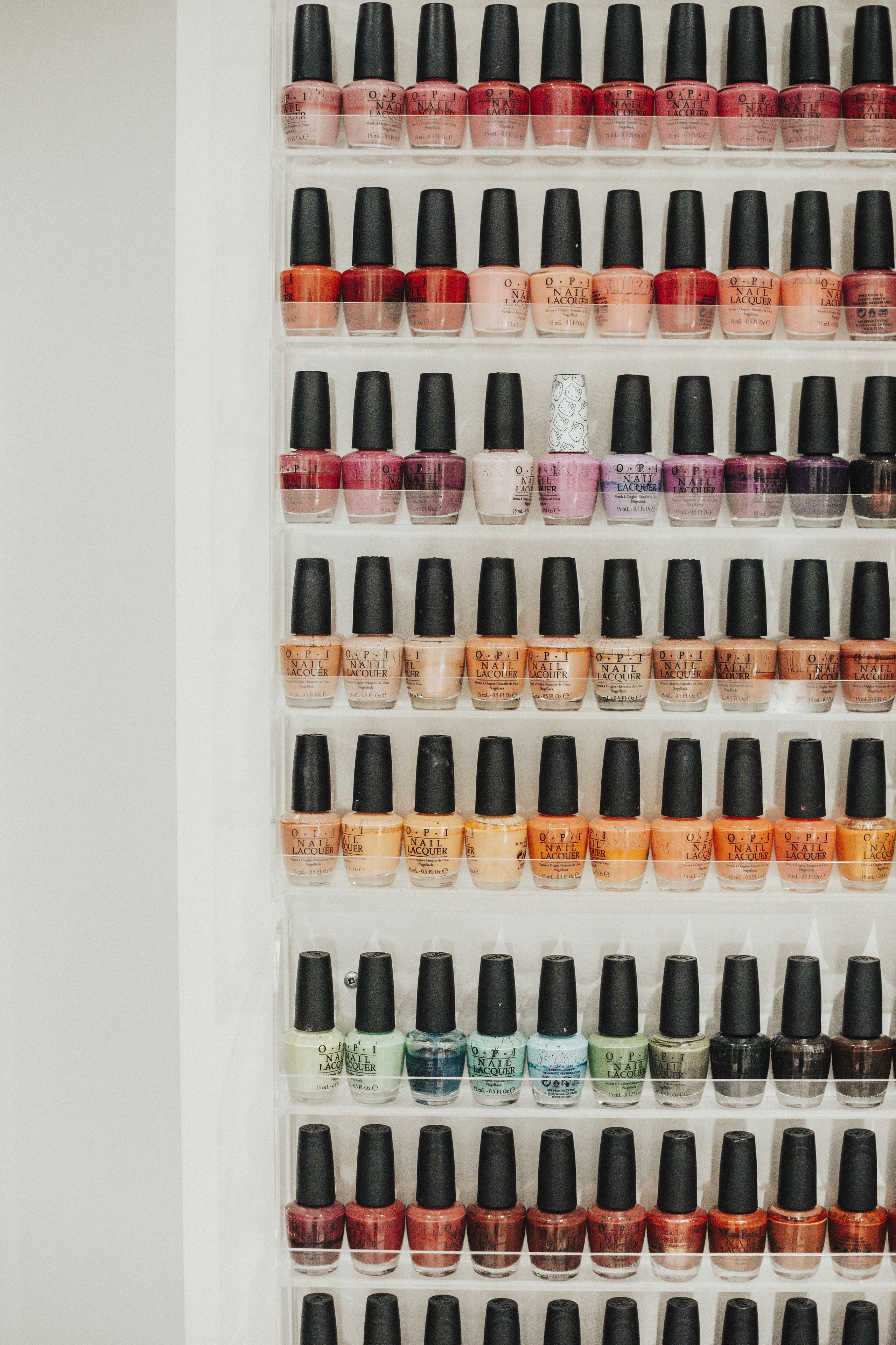 A wall of OPI nail polish bottles organized in rows and columns.