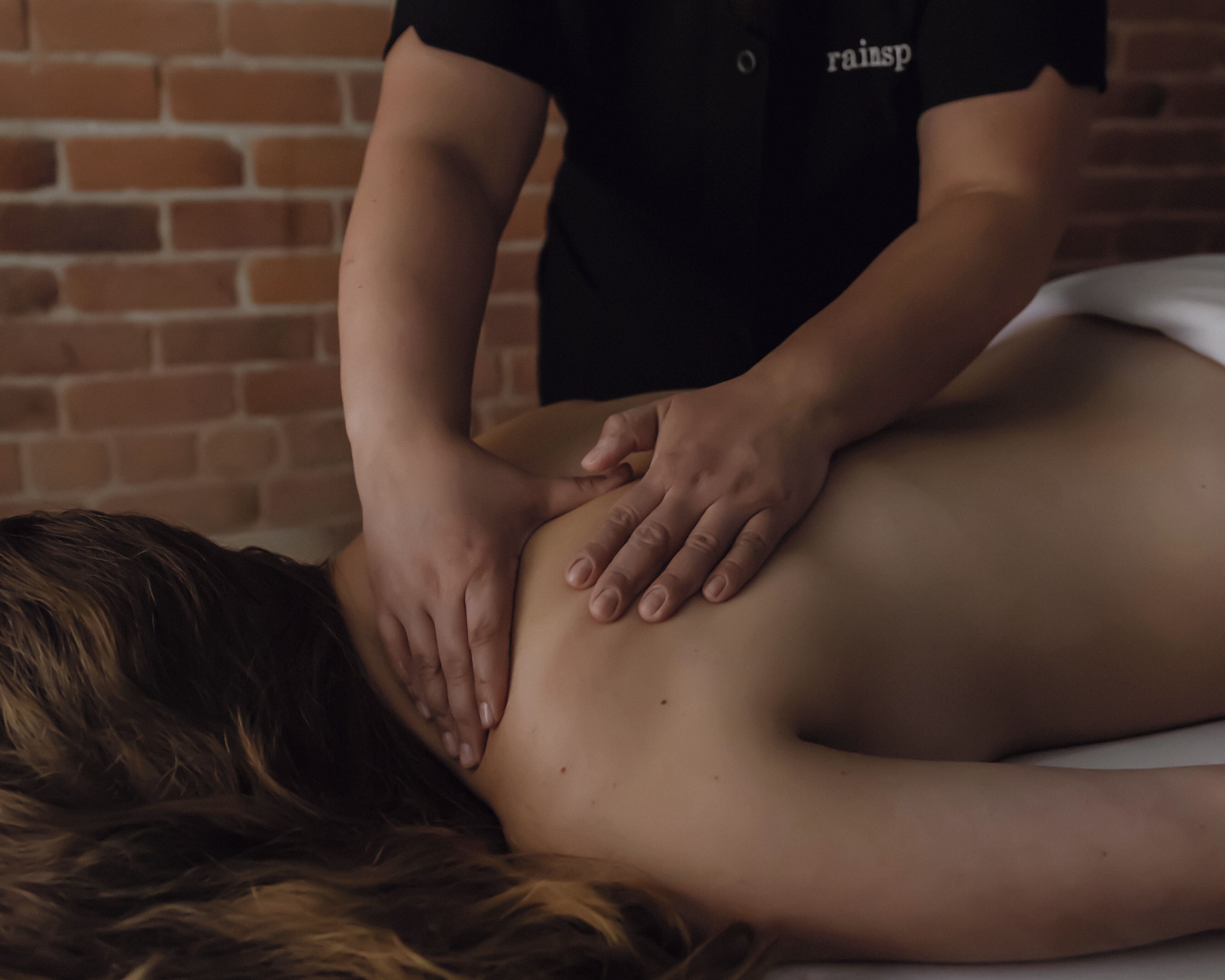 A person receiving a back massage.