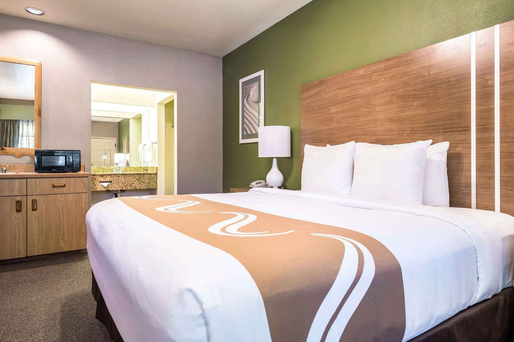 Premium bedding, laptop workspace, iron/ironing board