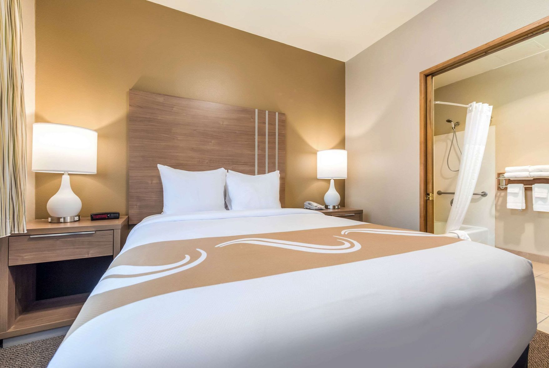 Premium bedding, laptop workspace, iron/ironing board