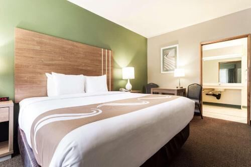 Premium bedding, laptop workspace, iron/ironing board