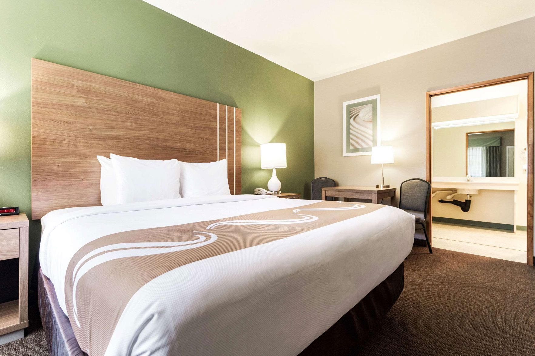 Premium bedding, laptop workspace, iron/ironing board
