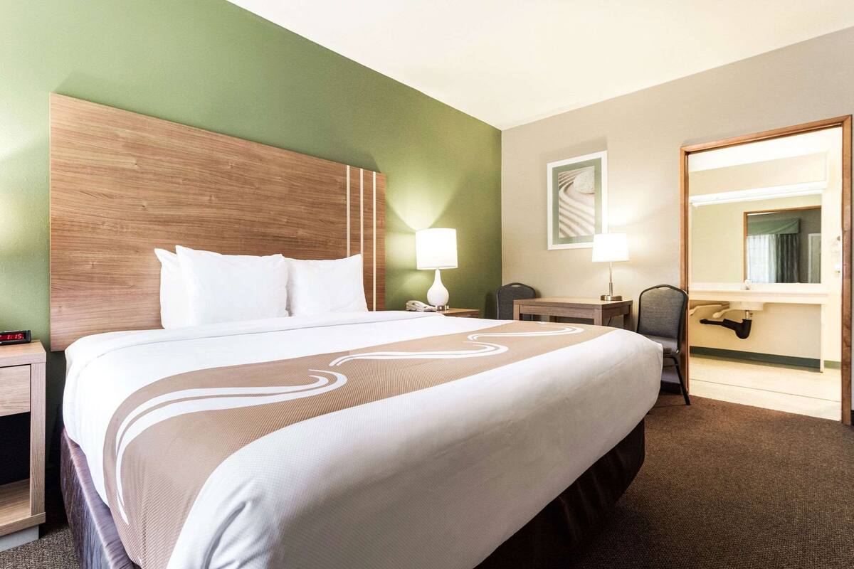 Premium bedding, laptop workspace, iron/ironing board