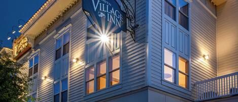 A two-story building with a sign reading "Fairhaven Village Inn" and a number "1200" above the entrance.