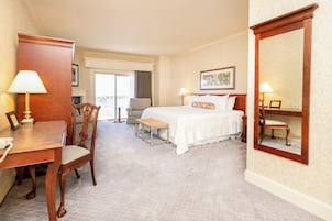 Premium bedding, desk, laptop workspace, blackout drapes