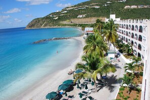 On the beach, white sand, sun loungers, beach umbrellas