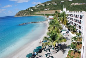 On the beach, white sand, sun loungers, beach umbrellas