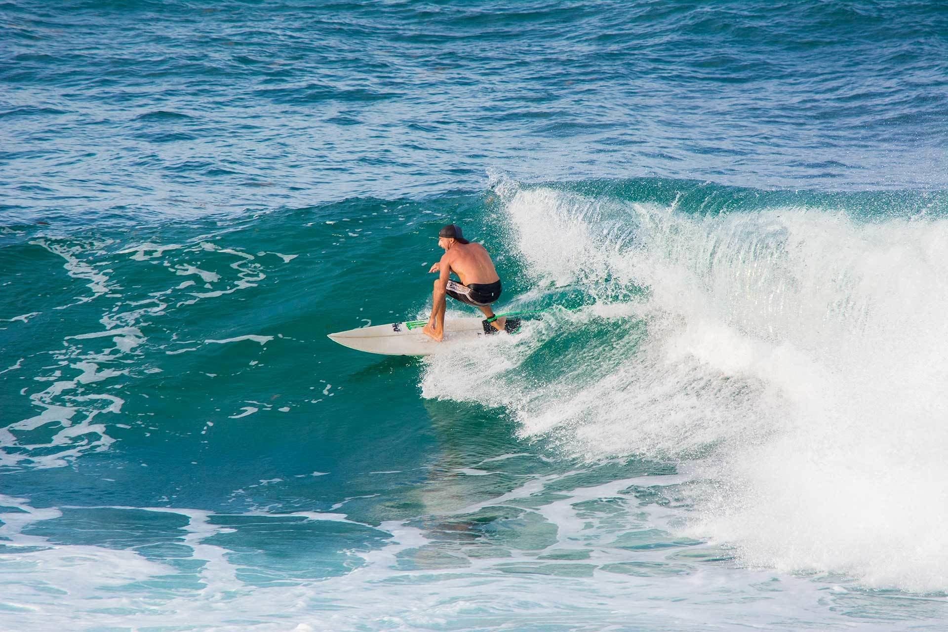 A person surfing on a wave in the ocean.