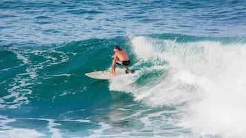 A person surfing on a wave in the ocean.