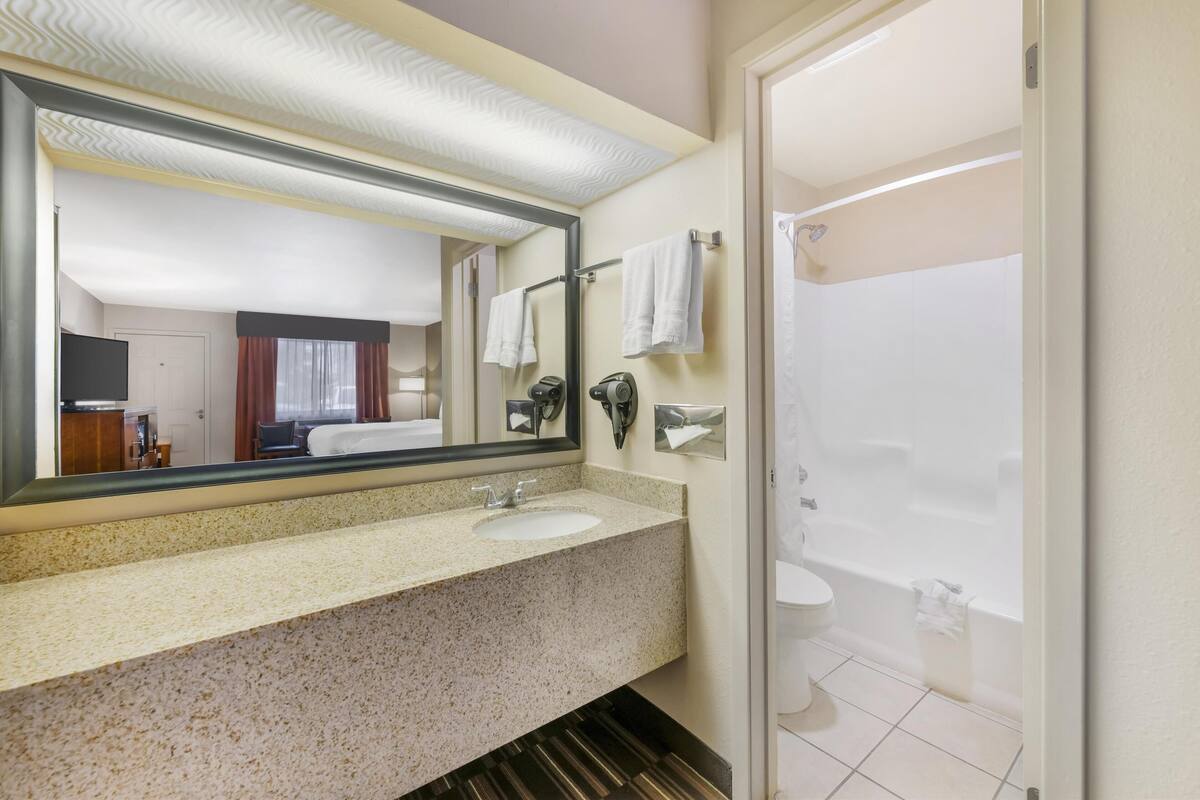 standard room, 2 queen beds, non smoking, refrigerator & microwave | bathroom | combined shower/bathtub, free toiletries, hair dryer, towels