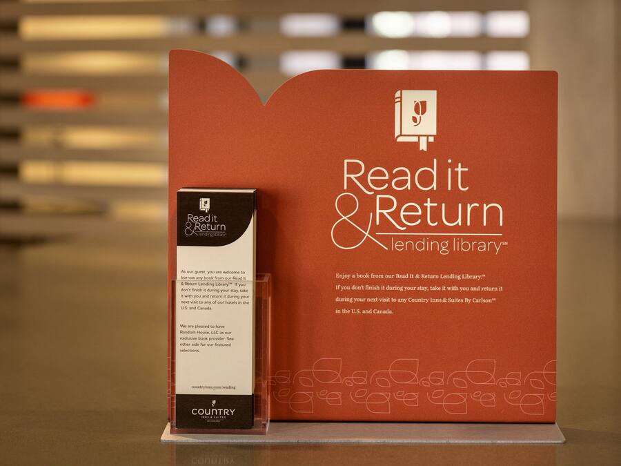 A promotional display for a Read it & Return Lending Library, featuring a book and a box with information.