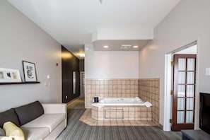 A modern bathroom with a bathtub, a shower, and a toilet. - Country Inn & Suites by Radisson, Fond du Lac, WI (Fond du Lac)
