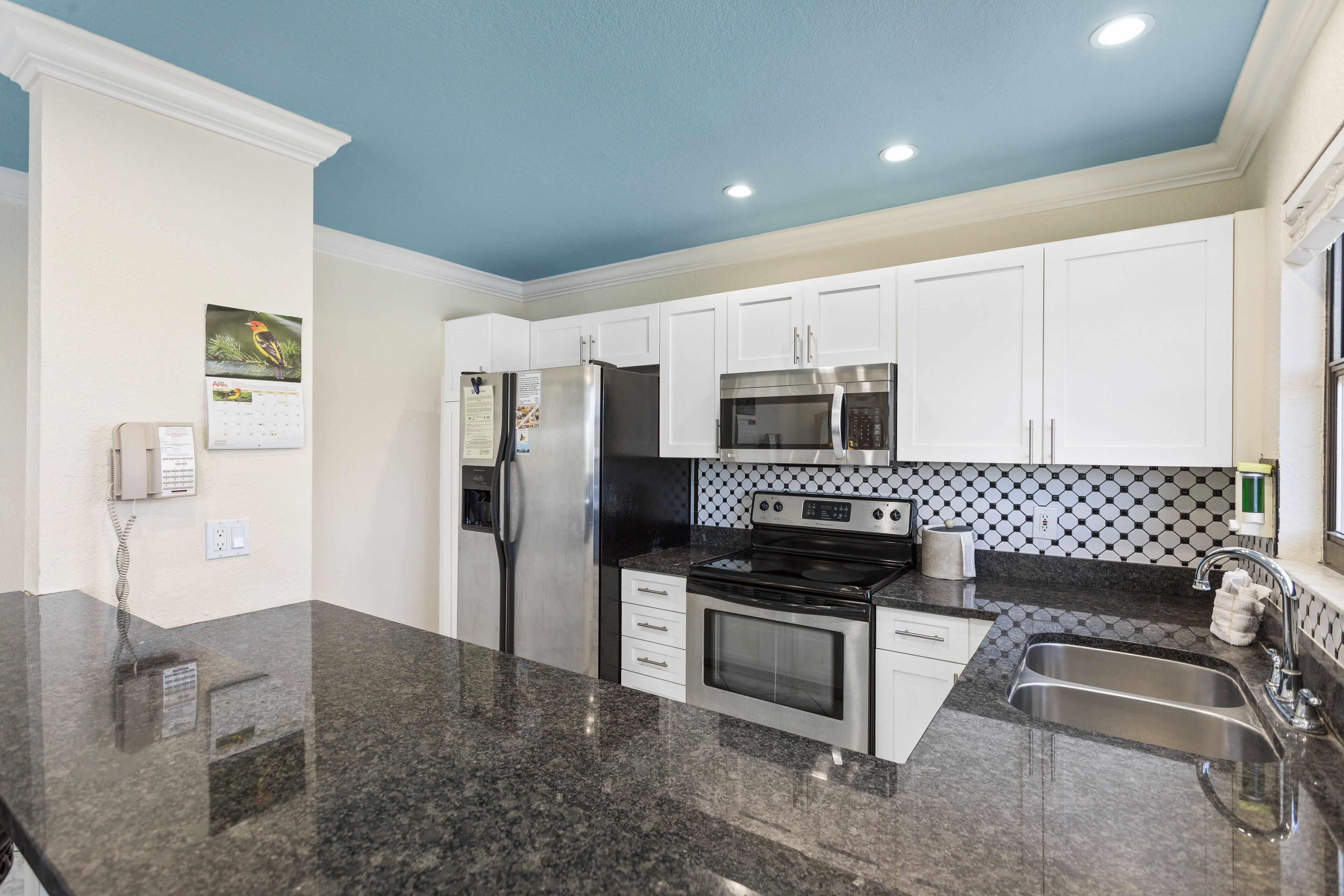 full-sized fridge, microwave, stovetop, coffee/tea maker