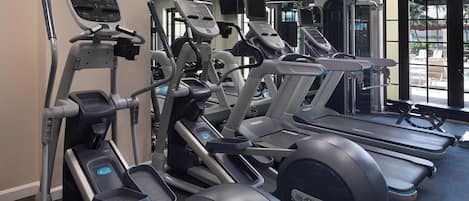 A gym with treadmills, elliptical machines, and weight machines.