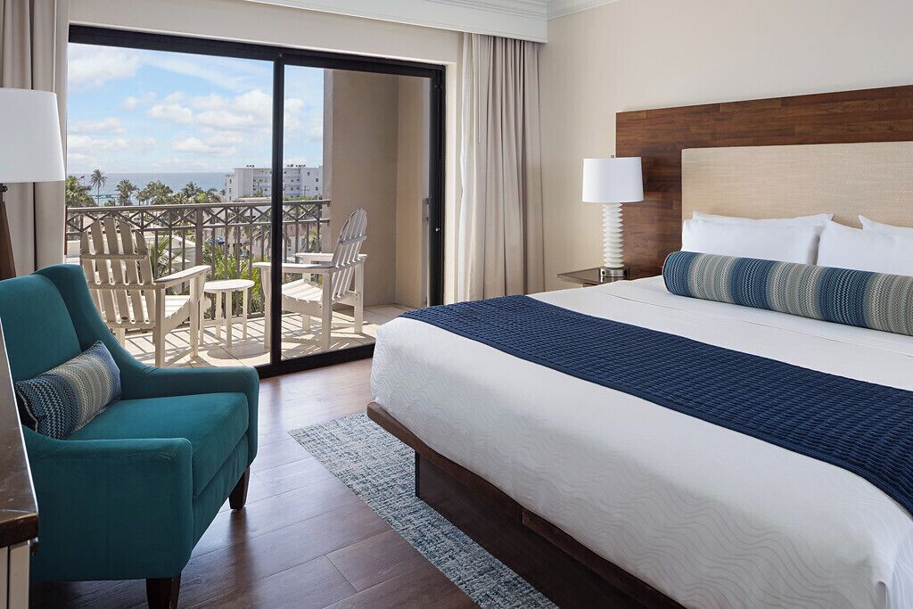 suite, 1 king bed with sofa bed, ocean view | in-room safe, iron/ironing board, bed sheets, alarm clocks