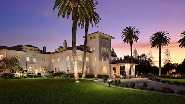 A large, multi-story building with a symmetrical facade, multiple windows, and a well-maintained lawn with palm trees. - Hayes Mansion, San Jose - Curio Collection by Hilton (San Jose)