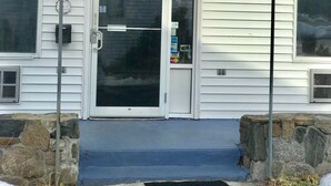 A hotel entrance with a blue awning displaying the name "AmeriVuu INN & SUITES". - AmeriVu Inn & Suites (Wolcott)