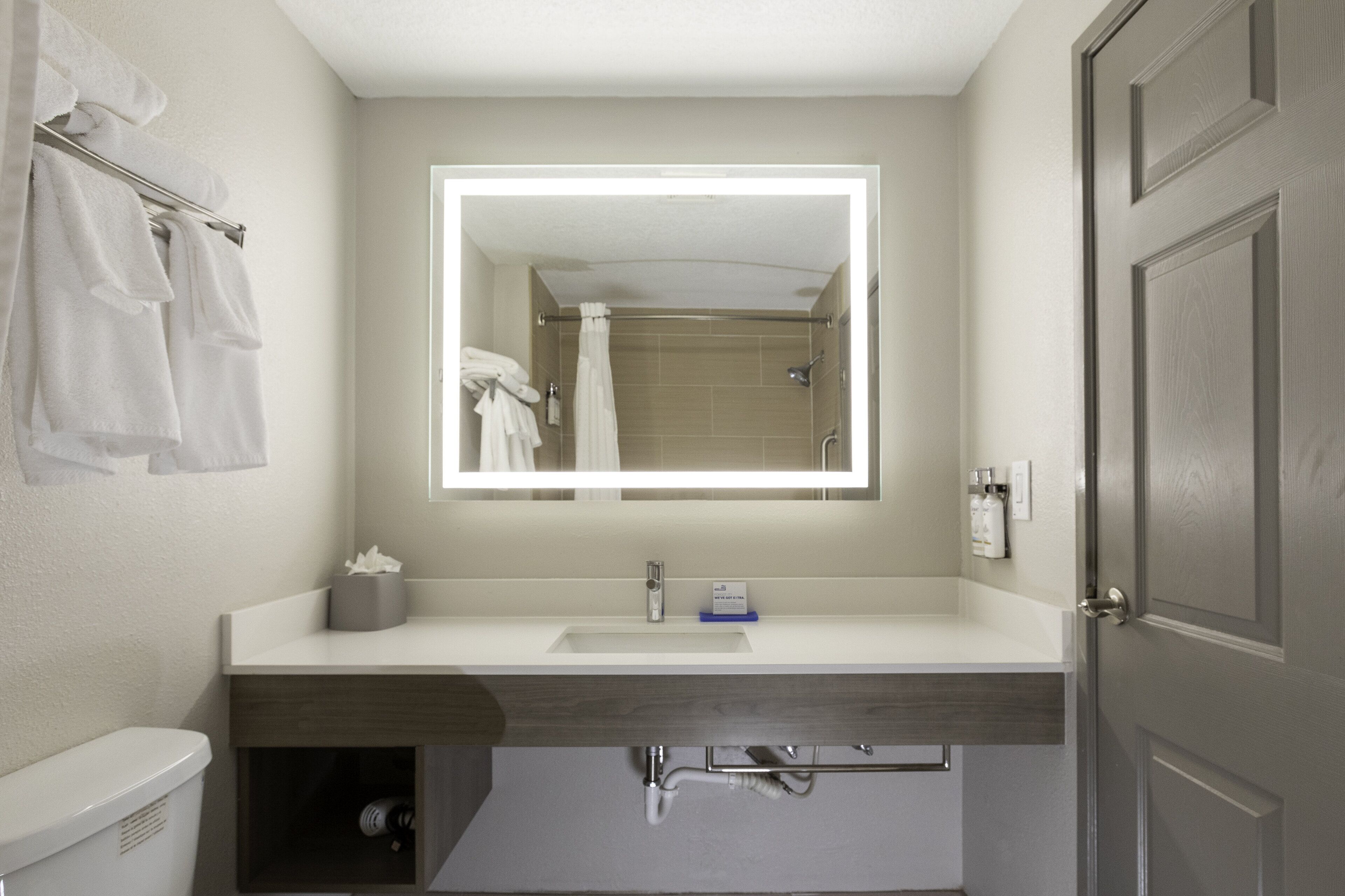 combined shower/bathtub, designer toiletries, hair dryer, towels