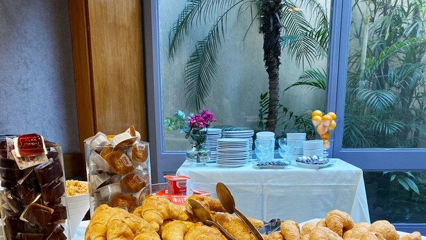 A breakfast buffet with various pastries, bread, and spreads. - Lafayette Hotel (Buenos Aires)
