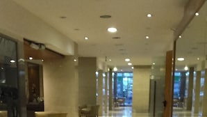 A spacious corridor with a polished floor, glass walls, and recessed lighting. - Lafayette Hotel (Buenos Aires)