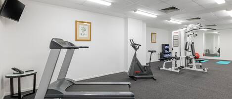 A gym with treadmills, stationary bikes, and weight machines.