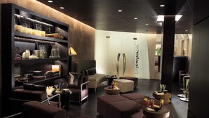 A modern lounge area with sofas, a coffee table, and a bookshelf with decorative items. - The Park Chennai (Chennai)