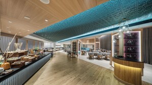 A spacious hotel lobby with wooden flooring, a central reception desk, and a decorative ceiling. - The Park Chennai (Chennai)