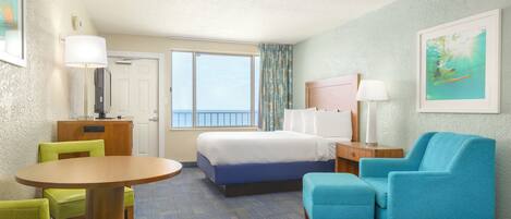 A hotel room with a bed, a desk, a chair, a round table, and a window.