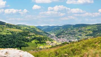 A valley with a town, rolling hills, and a clear sky.