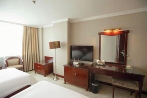 A hotel room with two beds, a desk with a flat-screen TV, a mirror, and a lamp. - Changxin International Hotel (Lanzhou)