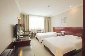 A hotel room with two beds, a desk, a chair, a television, and a window with curtains. - Changxin International Hotel (Lanzhou)