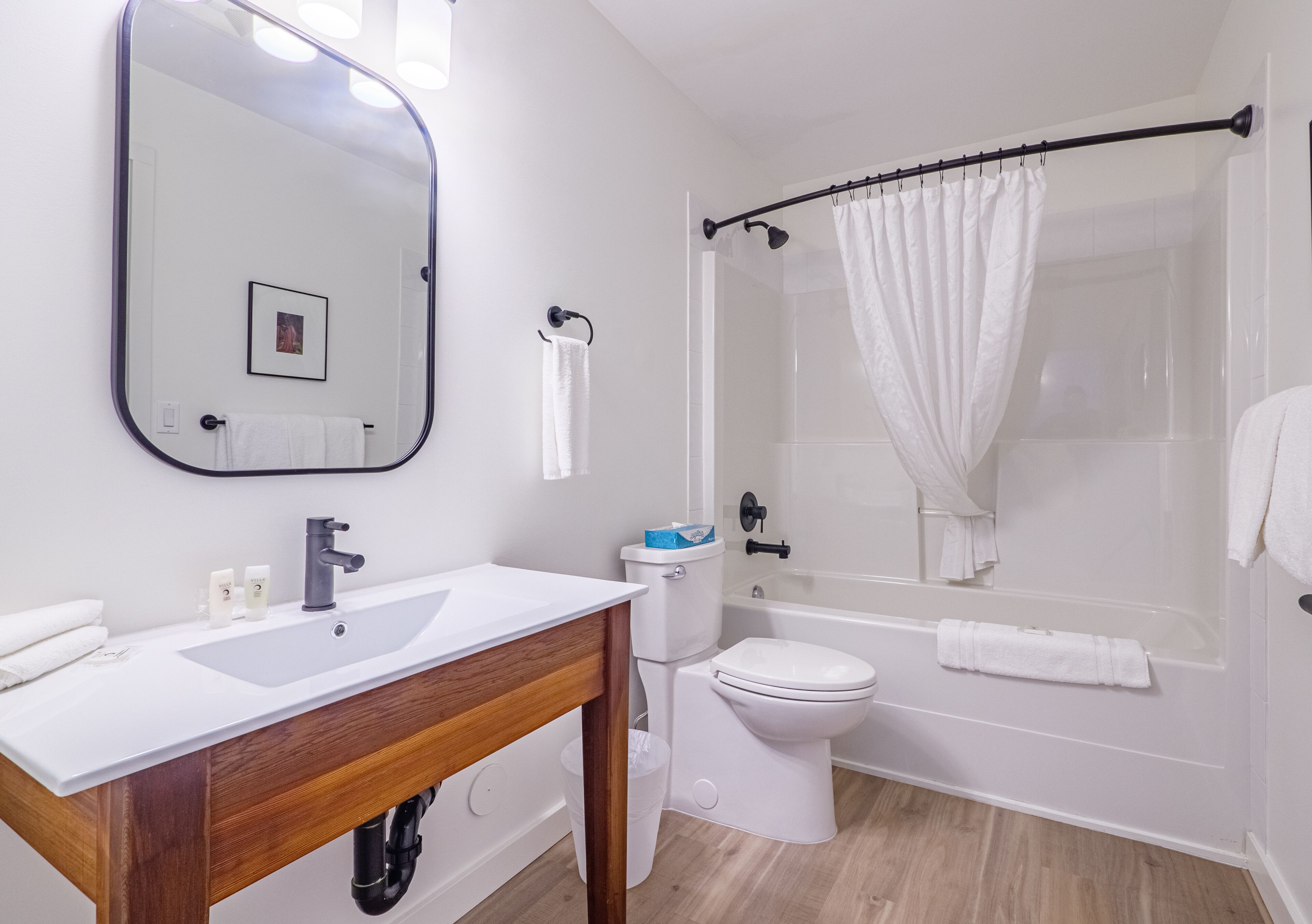 combined shower/bathtub, designer toiletries, hair dryer, bathrobes