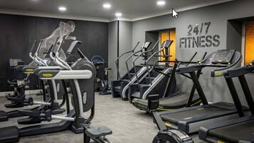 A gym with treadmills, ellipticals, and weight machines.