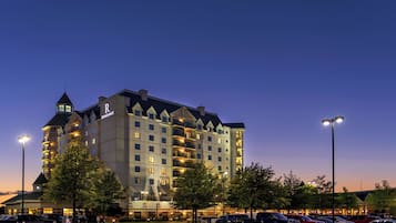Stunning hotel with a prominent tower and symmetrical facade, featuring evenly spaced windows and balconies.