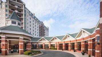 Stunning hotel entrance with a central driveway and covered seating area.