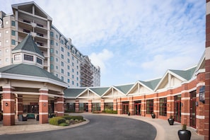 A hotel with a central courtyard, multiple floors, and a modern architectural design.