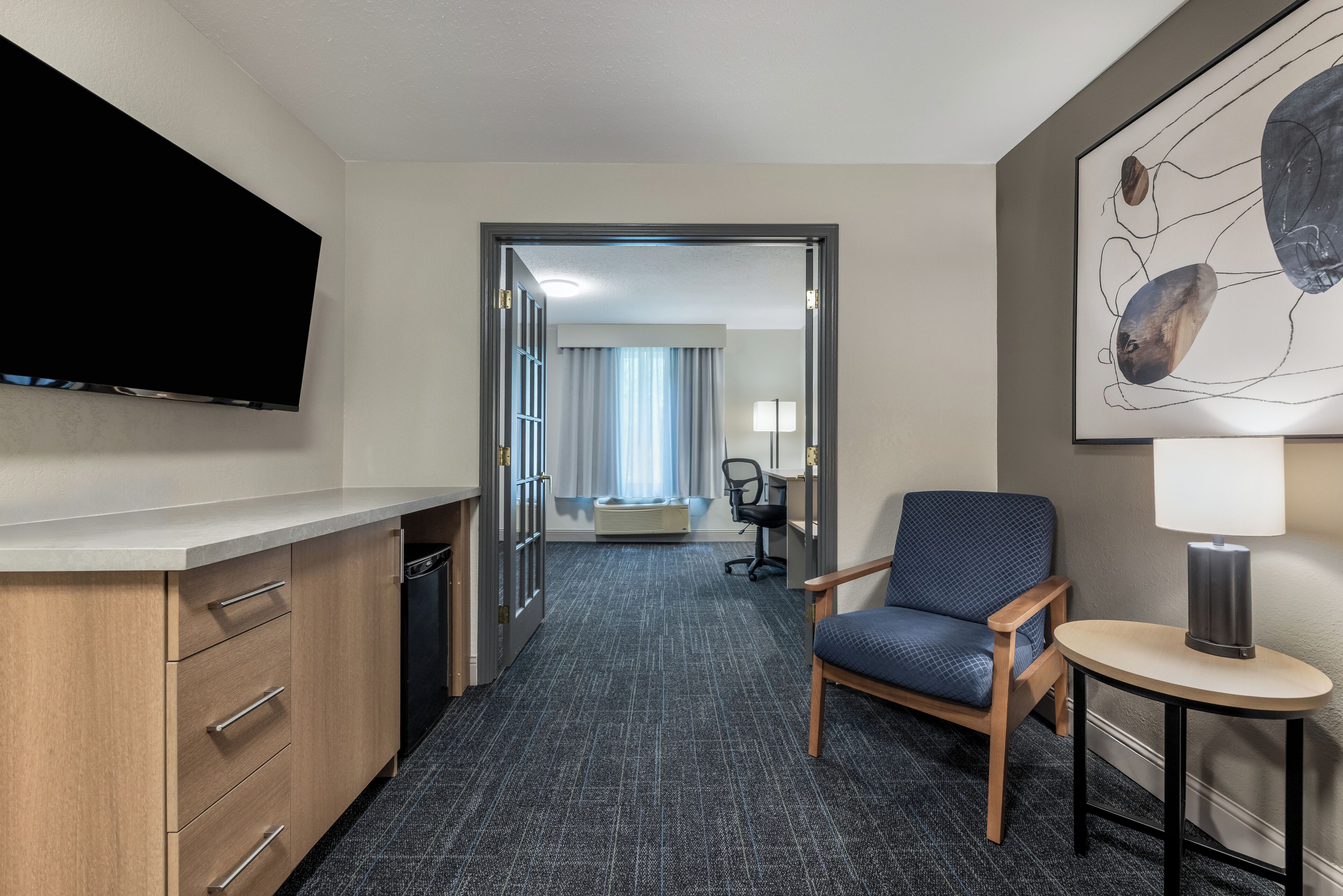 Premium bedding, laptop workspace, iron/ironing board
