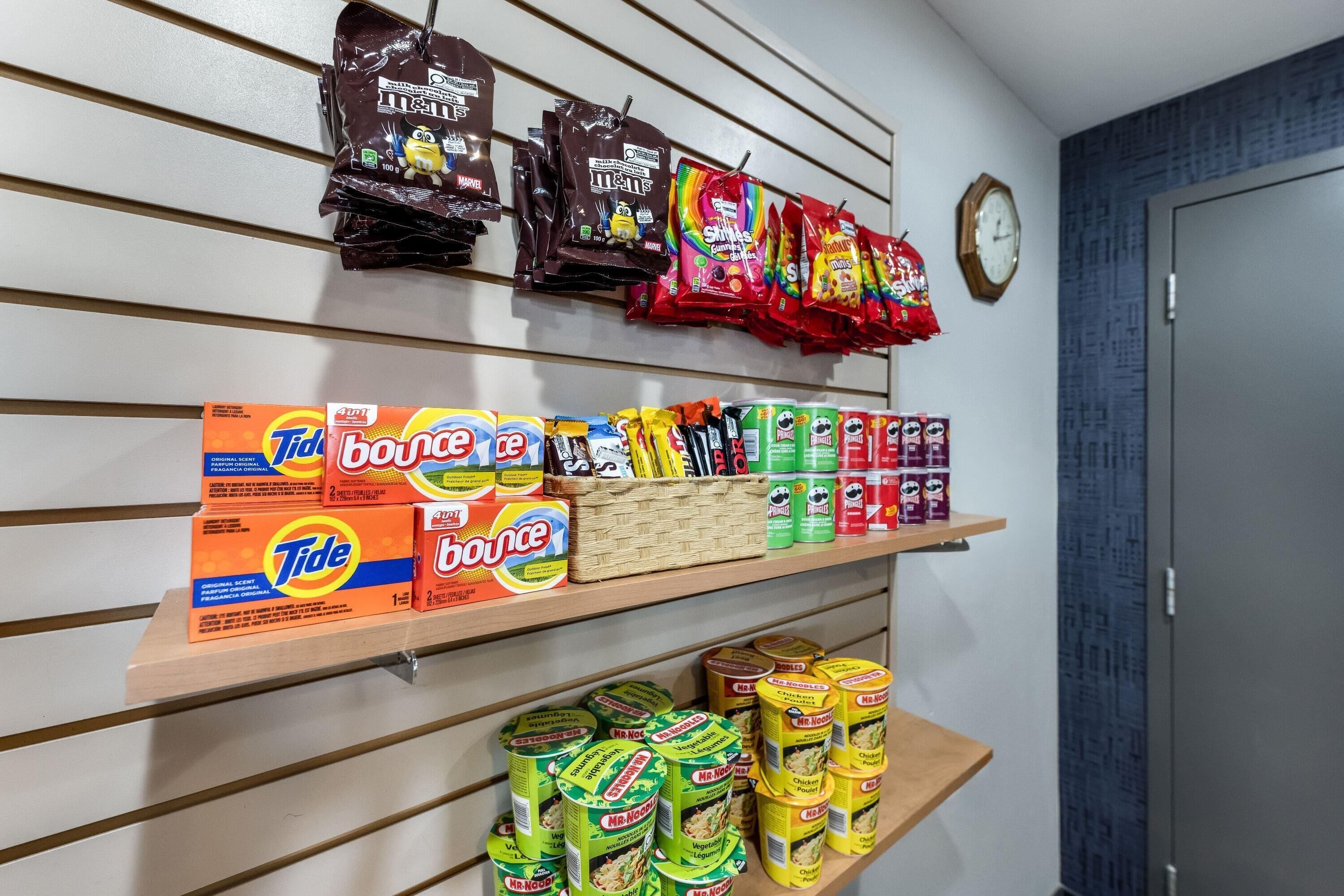 A shelf stocked with various snacks and household items.