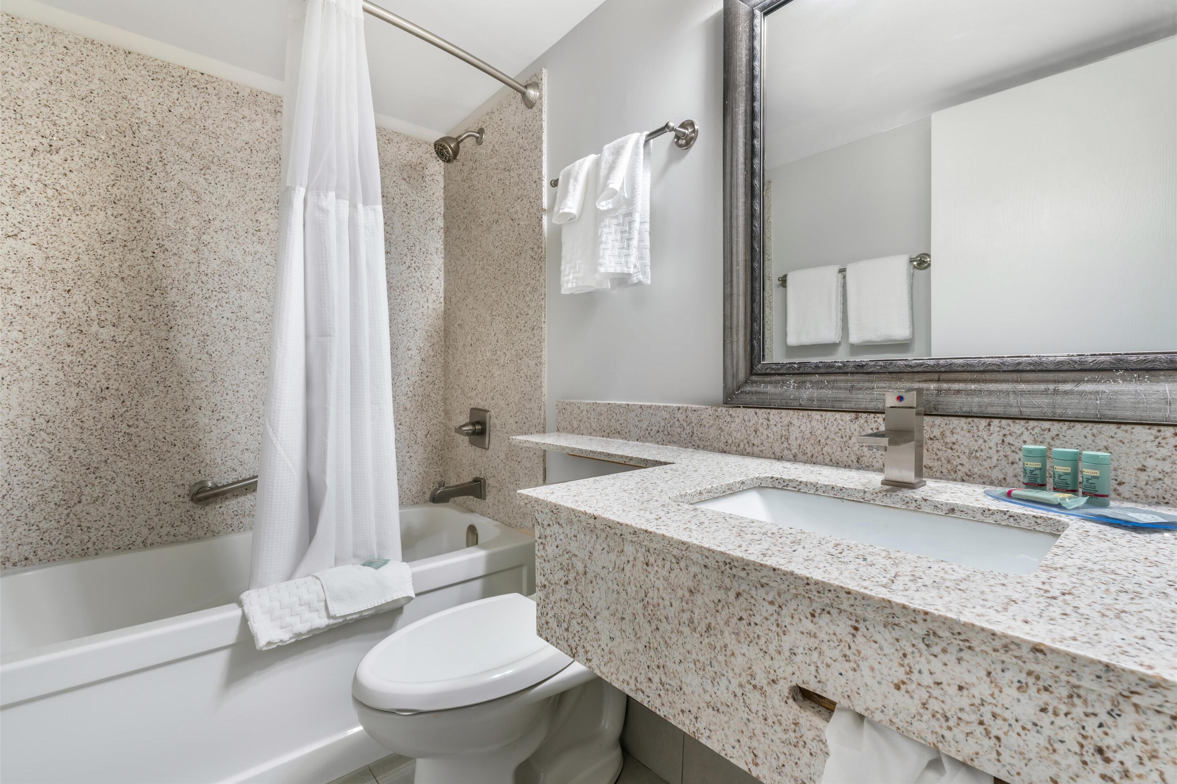 standard room, 2 queen beds, non smoking | bathroom | combined shower/bathtub, free toiletries, hair dryer, towels