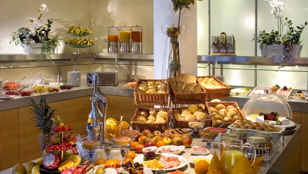 A buffet with various fruits, vegetables, and breakfast items.