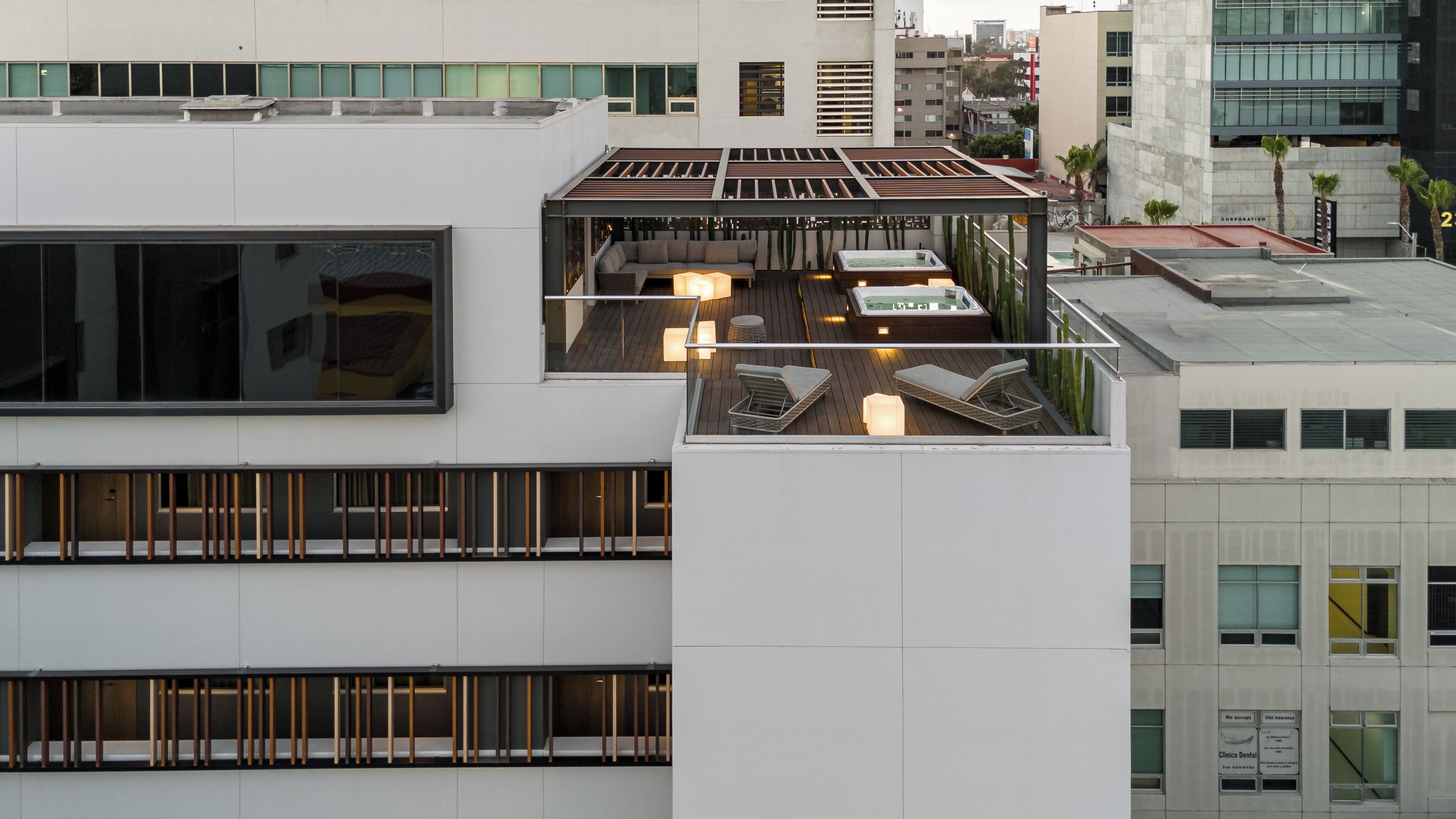 A rooftop terrace with a seating area, a hot tub, and a pool.