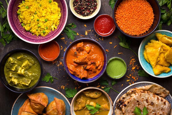 A variety of Indian dishes including rice, lentils, and curries. - Radisson Hotel Jalandhar Grand Windsor Resorts Ltd (Jalandhar)