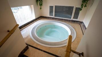 A hot tub in a corner with a view of the outside.