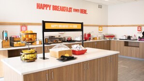 A breakfast station with a sign that reads 'HAPPY BREAKFAST STARTS HERE.' - Hampton Inn Shrewsbury (New Freedom)