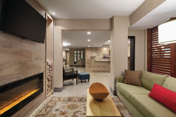 Relax in this stylish living room with a flat-screen TV, comfortable sofa, and dining area.