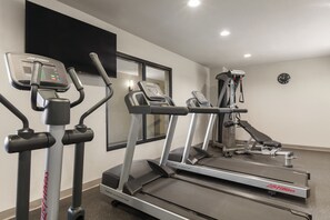 A gym with treadmills, ellipticals, and a rowing machine. - Country Inn & Suites by Radisson, Bakersfield, CA (Bakersfield)