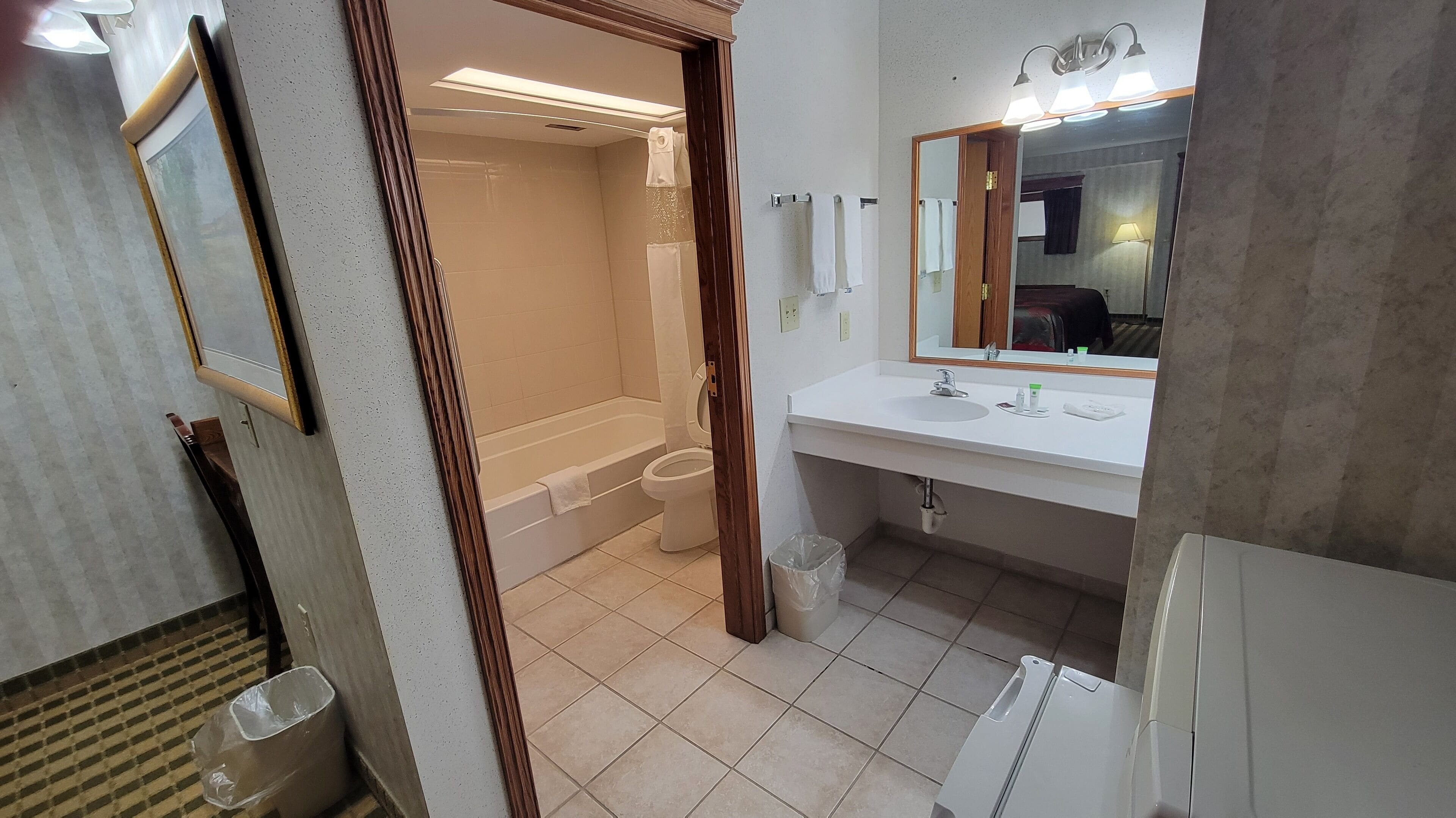 A bathroom with a bathtub, toilet, and sink.