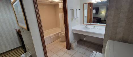 A bathroom with a bathtub, toilet, and sink.