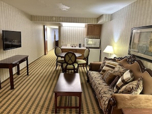 Suite, 1 King Bed, Non Smoking | Desk, laptop workspace, blackout drapes, iron/ironing board