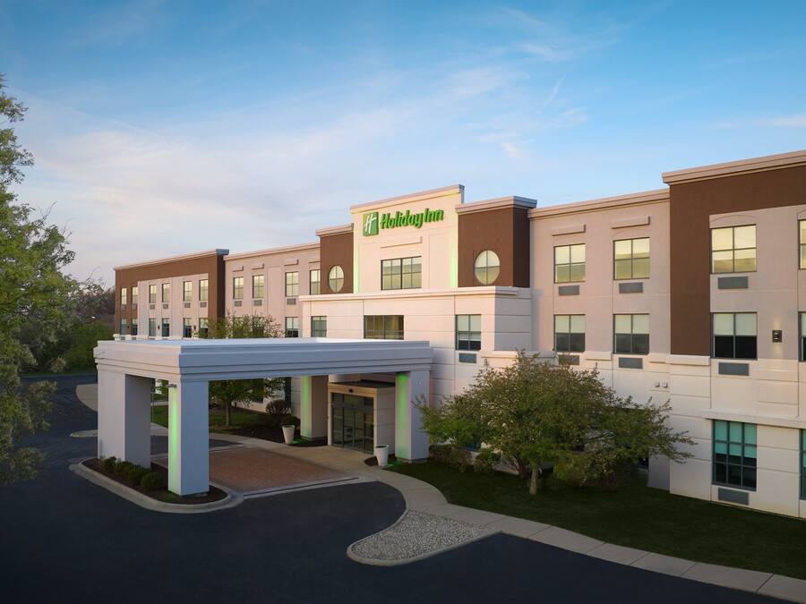 A Holiday Inn Express hotel with a modern facade, a covered entrance, and a landscaped driveway.